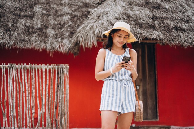 Asian business woman on a vacation talking on phone
